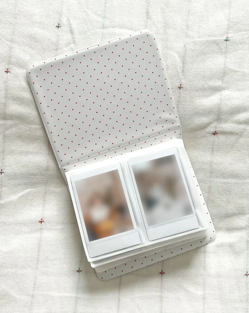 An open Polaroid album with pockets for printed photos